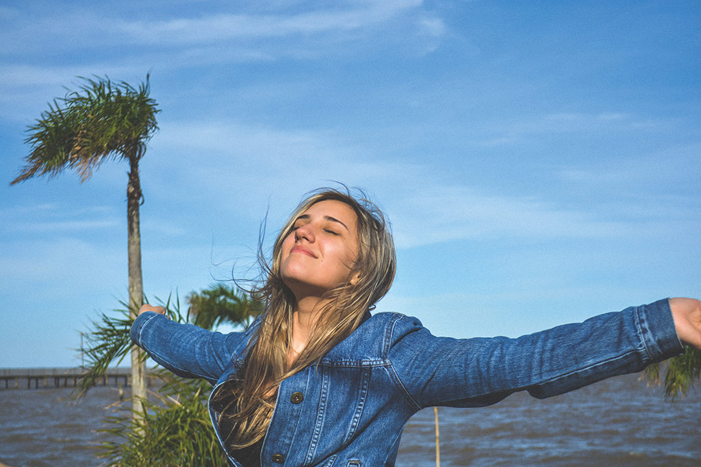 Young Woman Enjoying The Evening Breeze | Skinn Bar